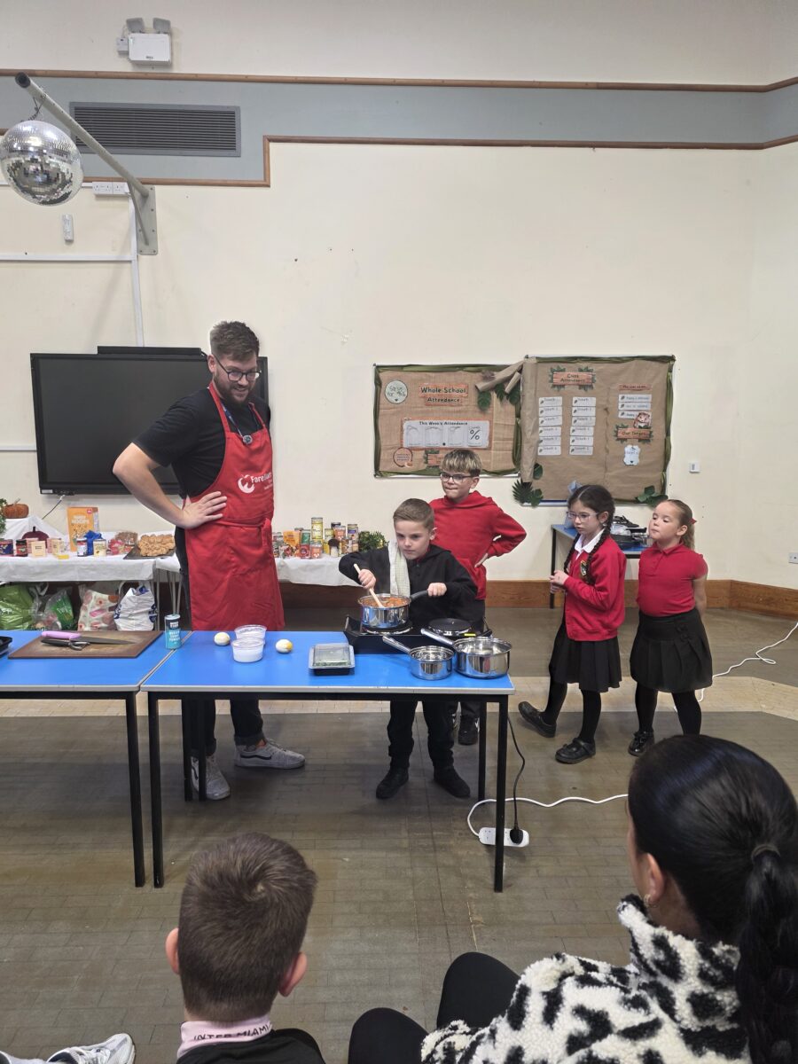 FareShare Culinary Lead supervising schoolchildren helping to make the curry