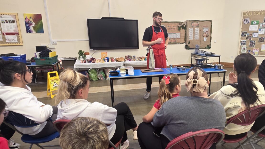 FareShare Cymru's Culinary Lead doing a cooking demonstration to parents and schoolchildren