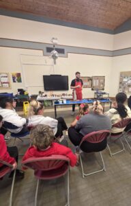 FareShare Cymru's Culinary Lead doing a cooking demonstration to parents and schoolchildren