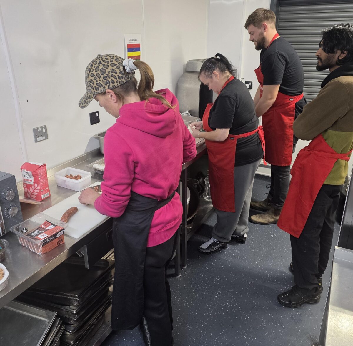 Service users being supervised during knife skills by Chef Liam at The Huggard